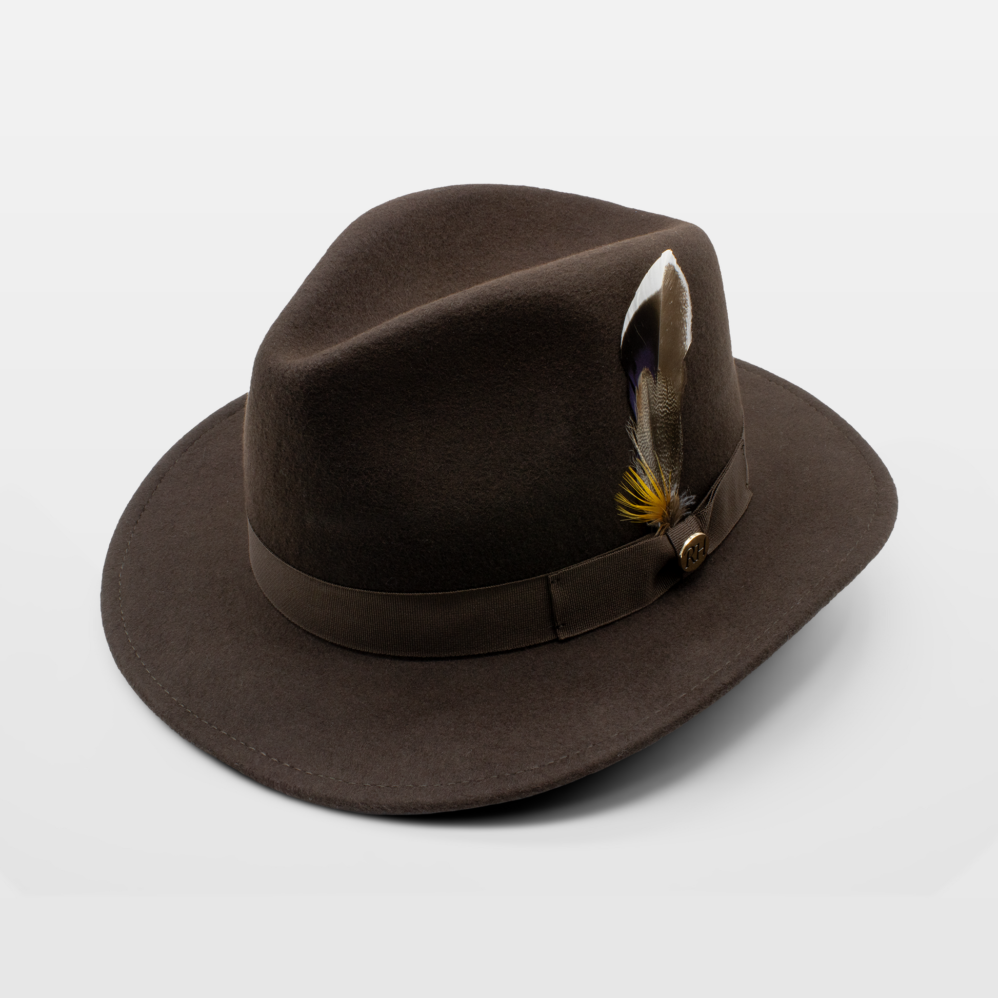 Brown felt fedora hat with a matching band and a feather accent