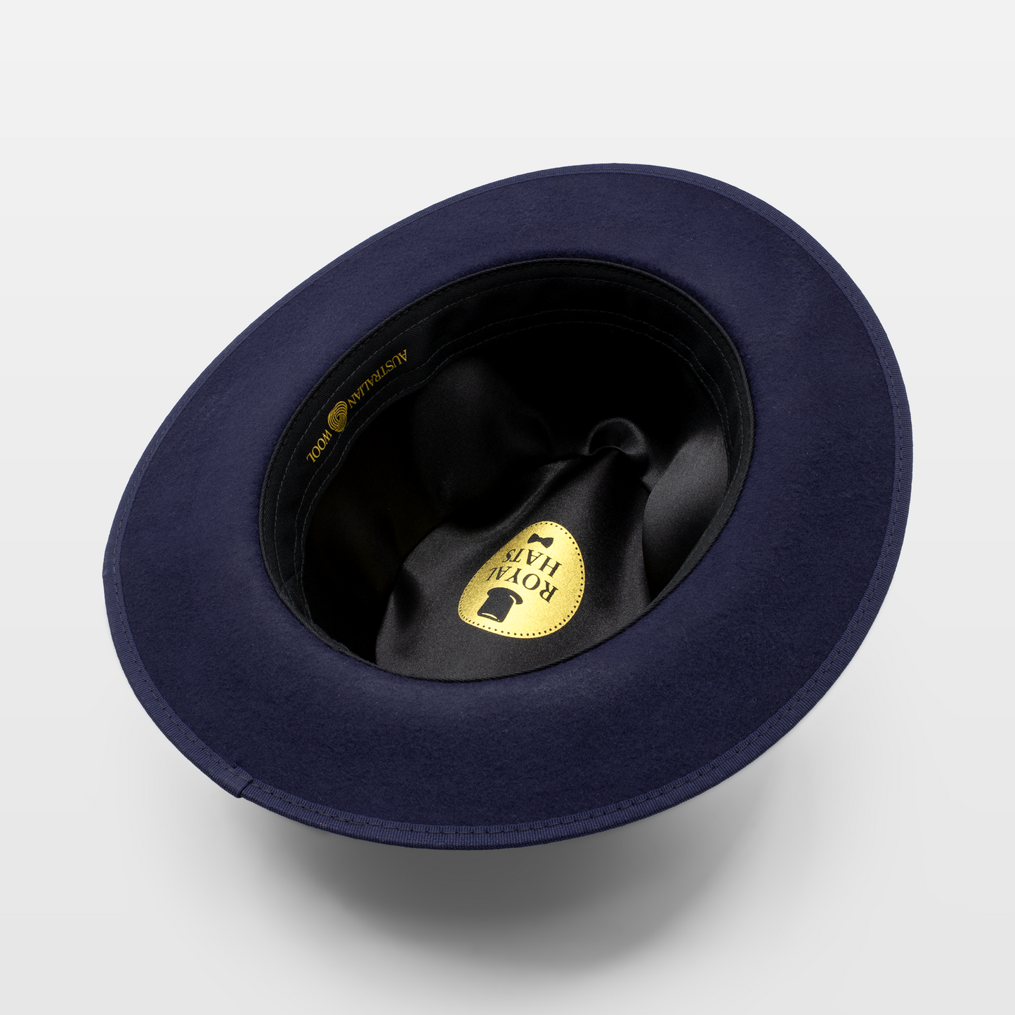 Interior view of a navy blue hat with a black lining and a Royal Hats label