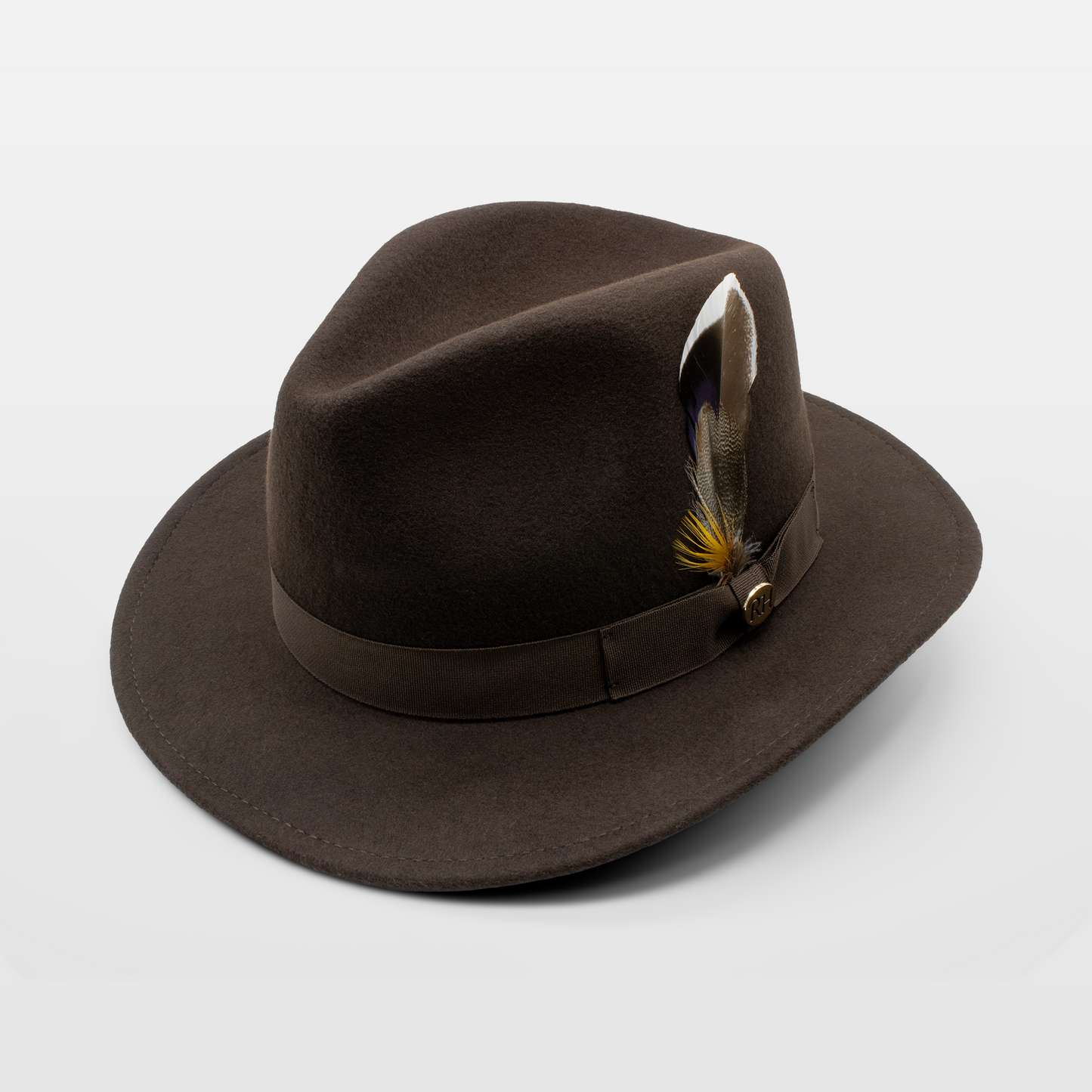 Brown felt fedora hat with a matching band and a feather accent