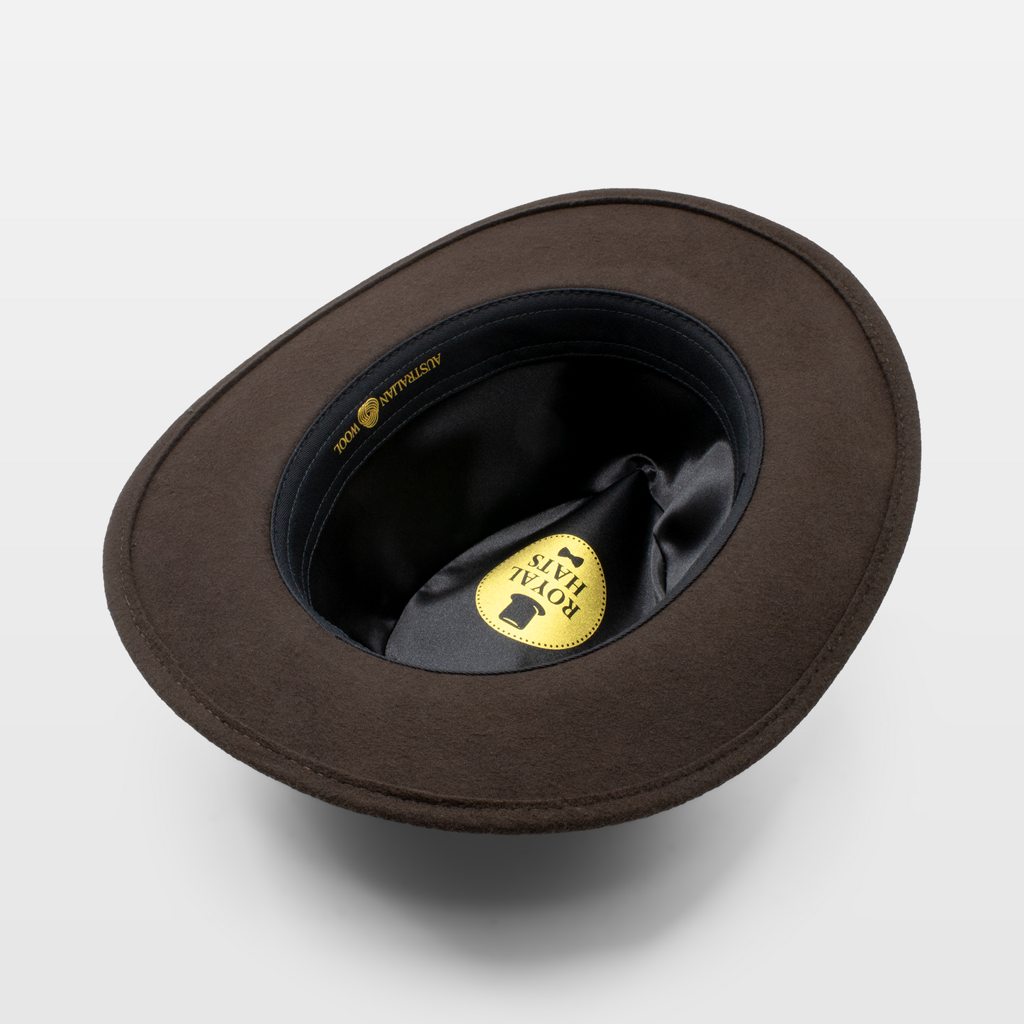 Interior view of a brown felt hat showing the Royal Hats label and satin lining