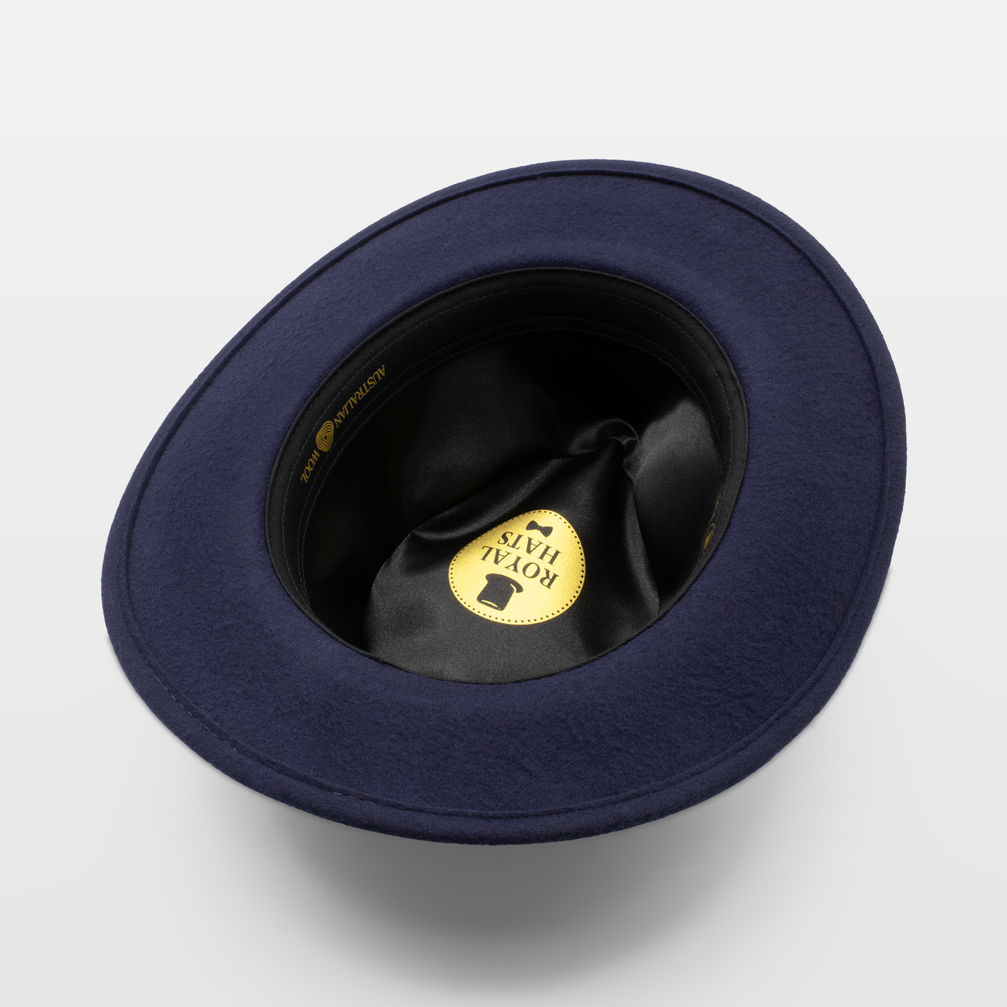 Interior view of a navy felt hat with a black satin lining, showing the Royal Hats logo