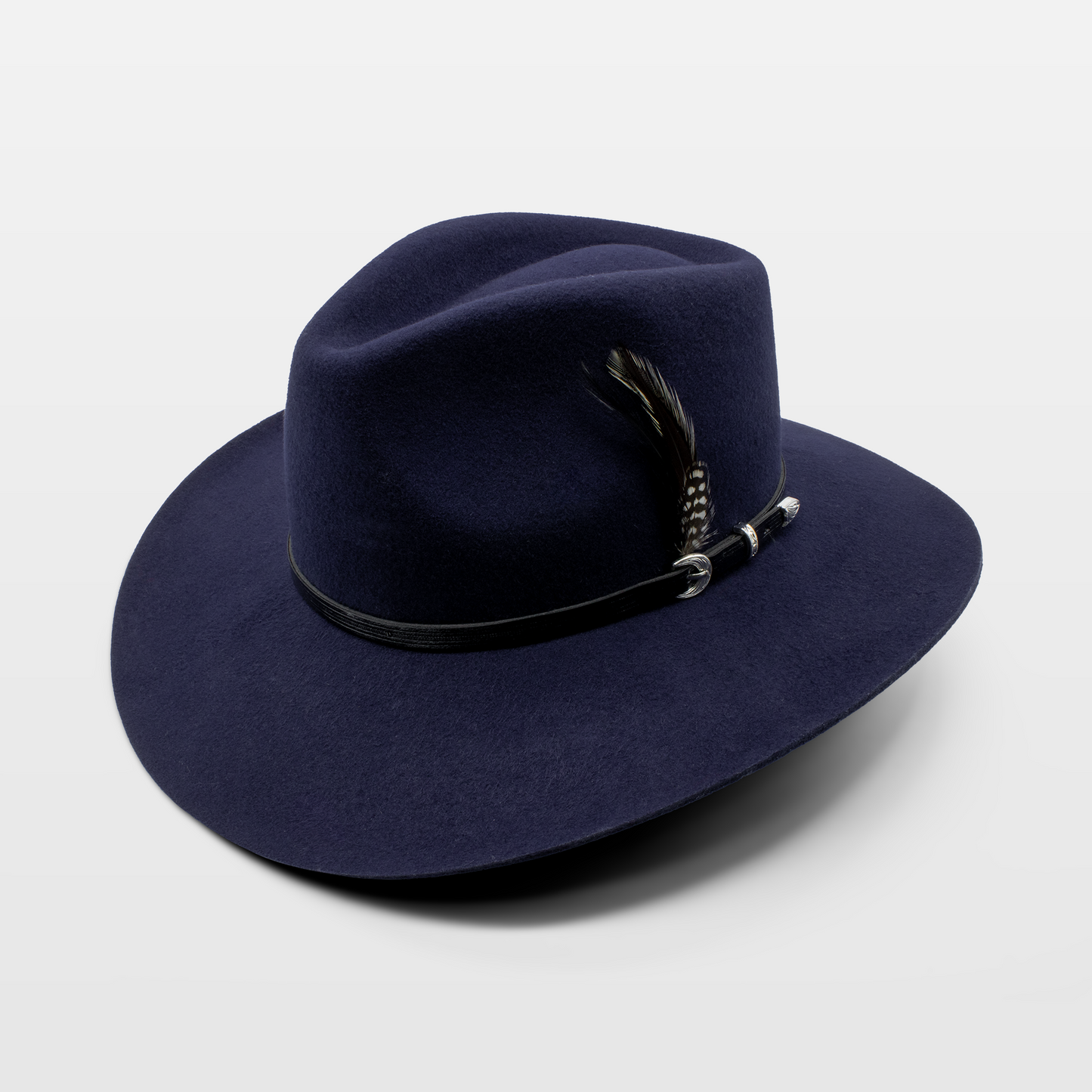 Navy blue wide-brim hat with a black band and a feather accent on the side