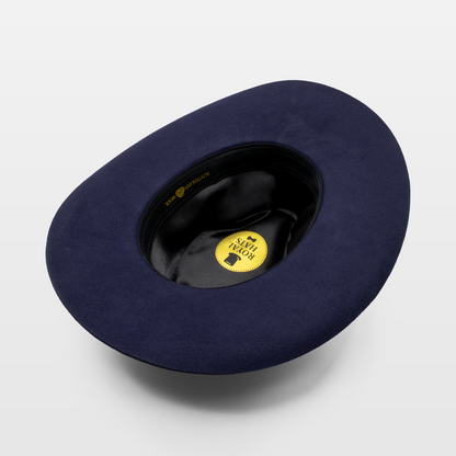 Interior view of a navy blue hat showing the Royal Hats label and satin lining