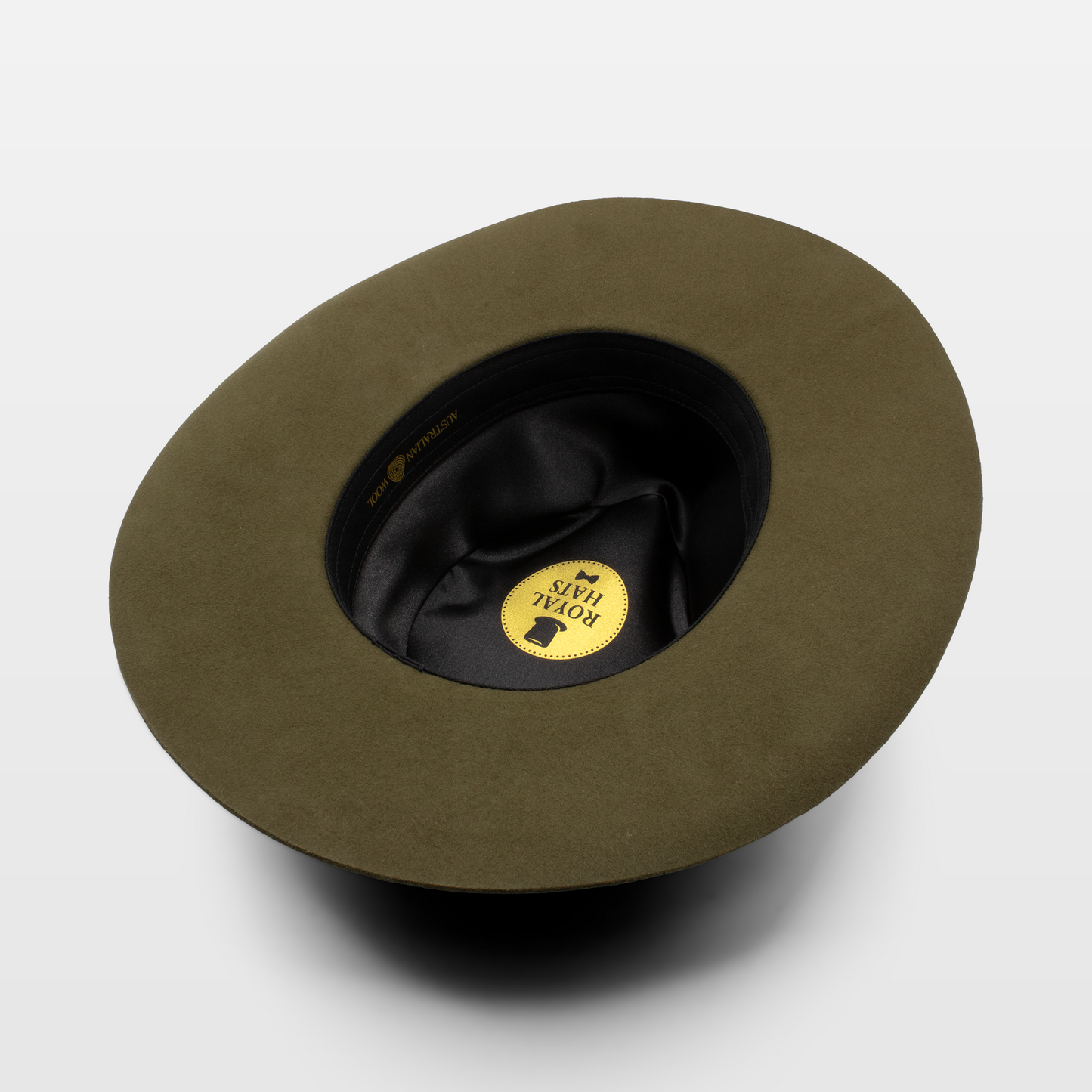 olive green Royal Hats fedora, showcasing the interior label and black lining