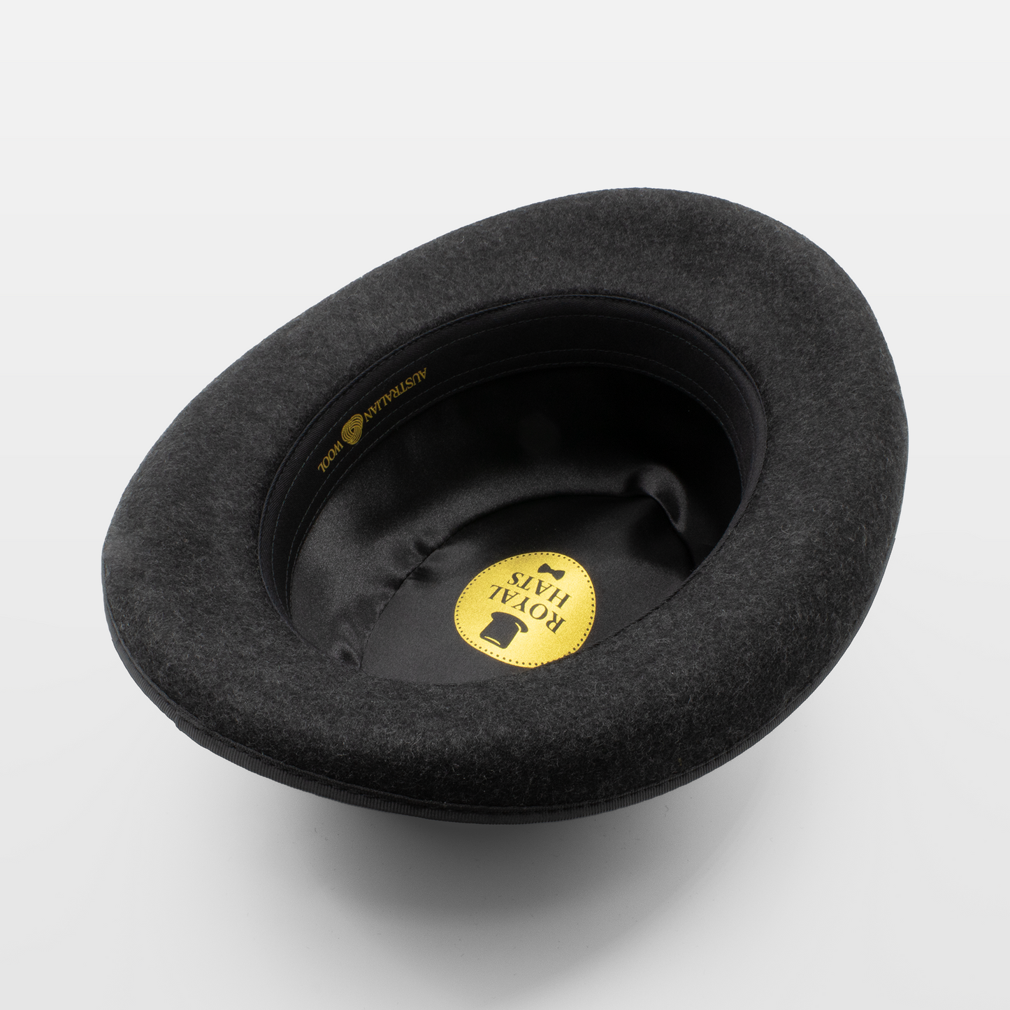 Interior view of a black Royal Hats fedora, showcasing the brand label and satin lining