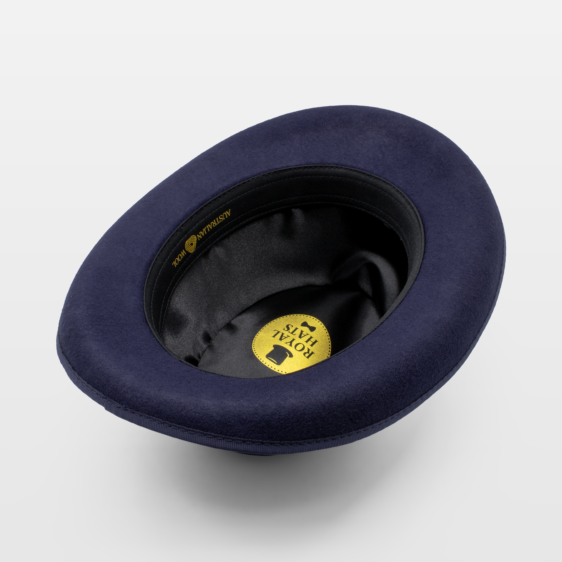 Interior view of a navy blue felt hat showing the Royal Hats logo and black lining.