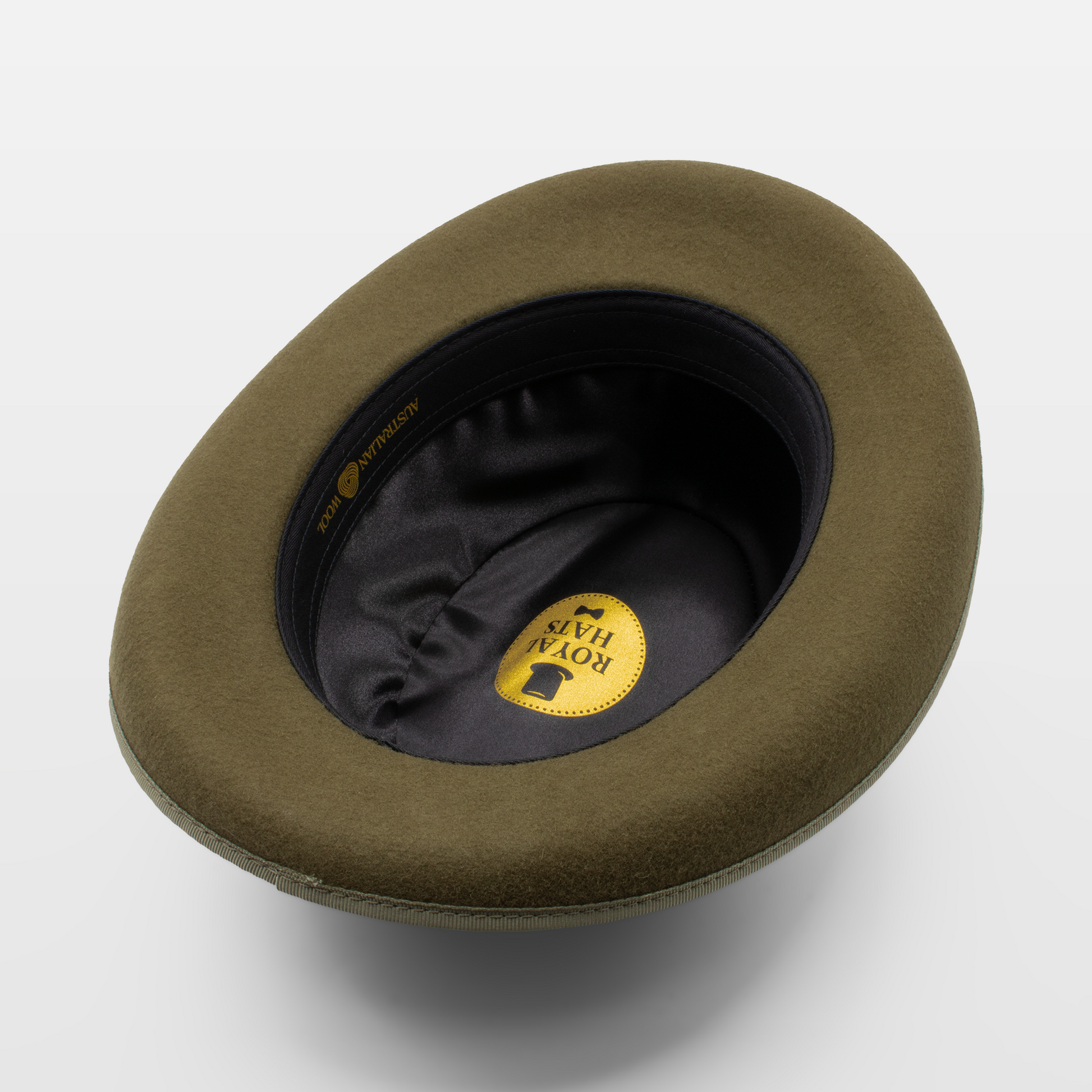 Inside view of an olive green felt hat showing the Royal Hats label and black lining