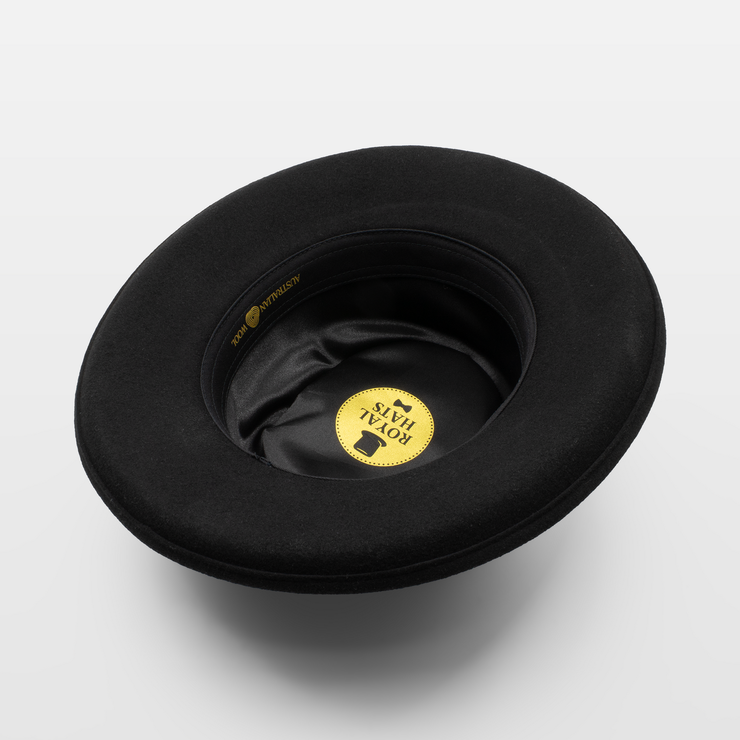 Interior view of a black Royal Hats fedora, showcasing the satin lining and branded label