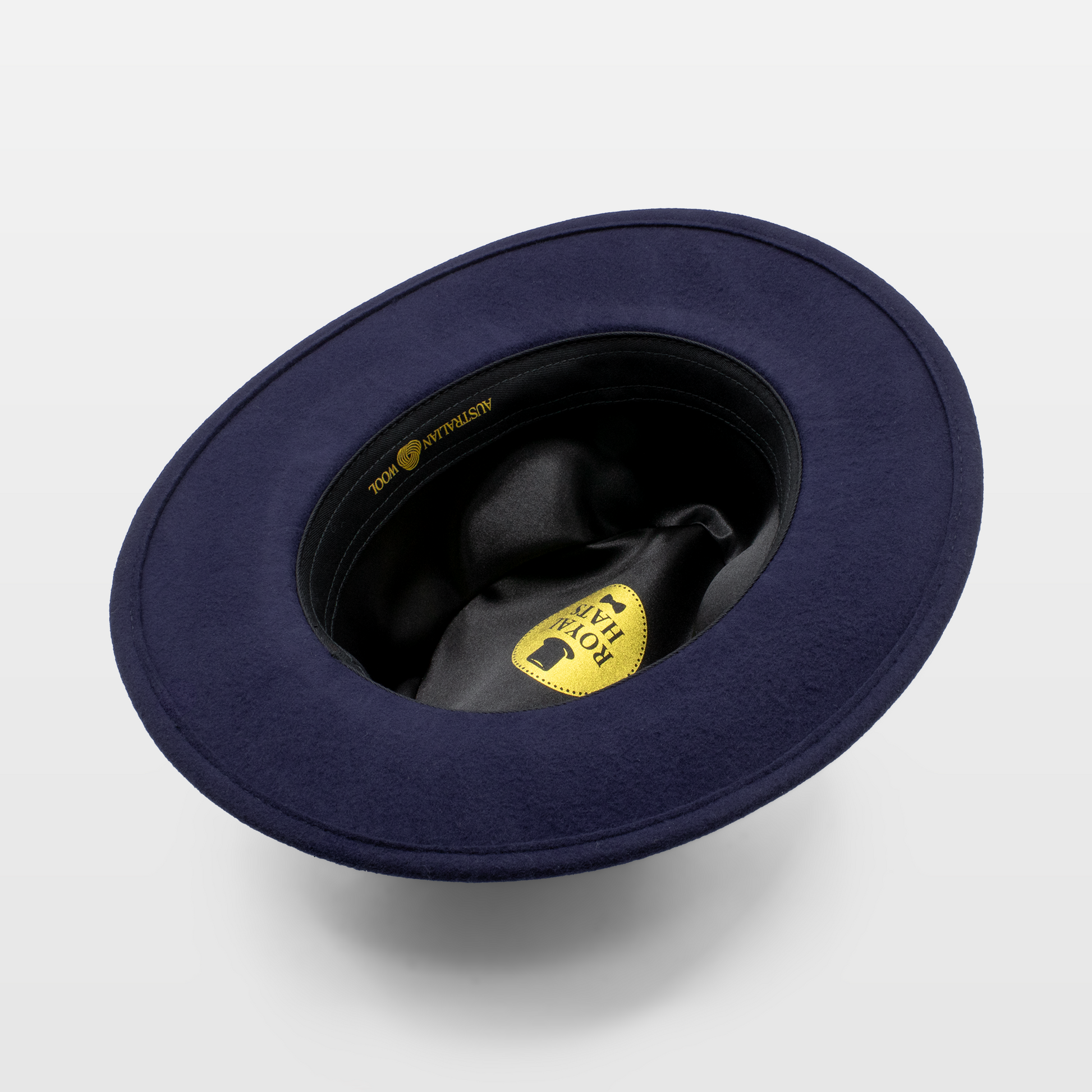 interior view of a navy felt hat showing the black satin lining