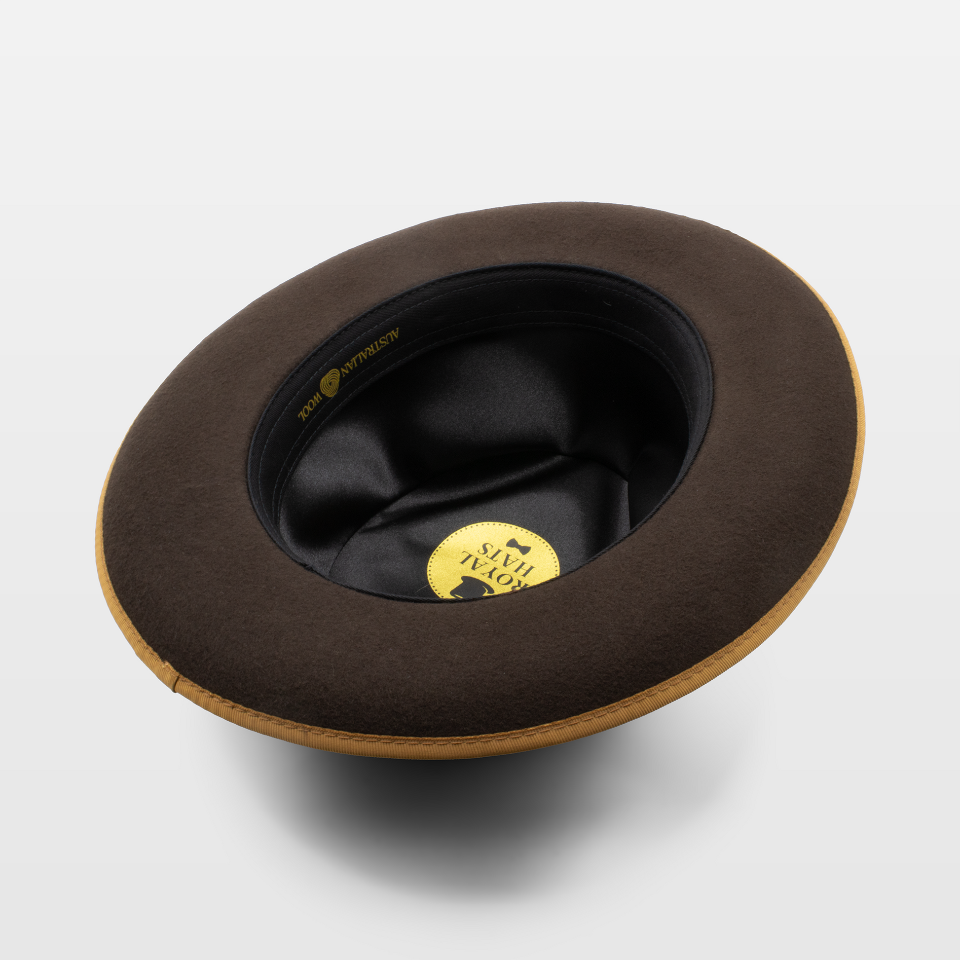 The inside view of a brown hat with a black interior