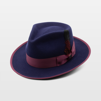 A stylish purple hat with a burgundy band and a decorative red feather