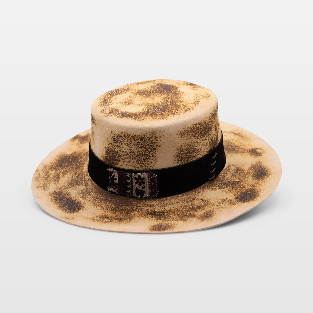 Beige wide-brimmed hat with a weathered look and a black band with embroidered details