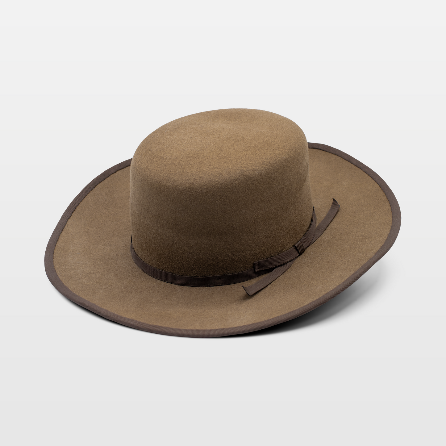 Brown wide-brimmed hat with a simple brown ribbon band and matching brim trim