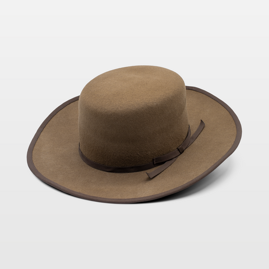 Brown wide-brimmed hat with a simple brown ribbon band and matching brim trim