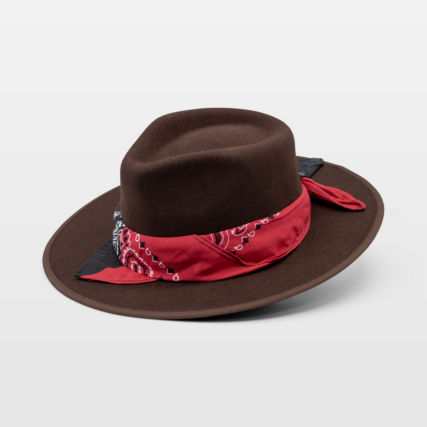 Brown wide-brim hat with a red bandana detail