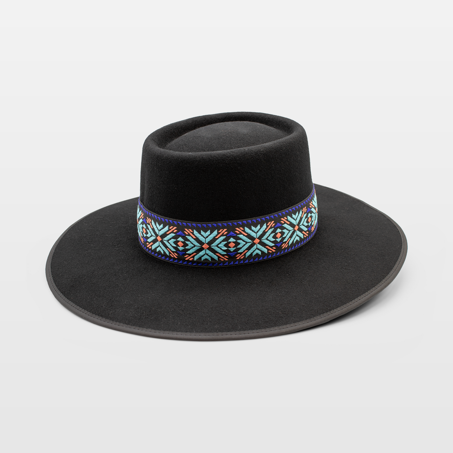 Black flat-brim hat with an intricately patterned band featuring vibrant colours