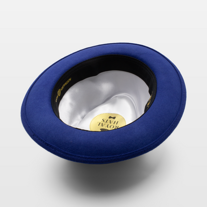 Blue fedora hat shown upside down to display the white satin interior and gold label