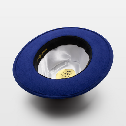 Blue wide-brimmed hat shown upside down to display the white satin interior