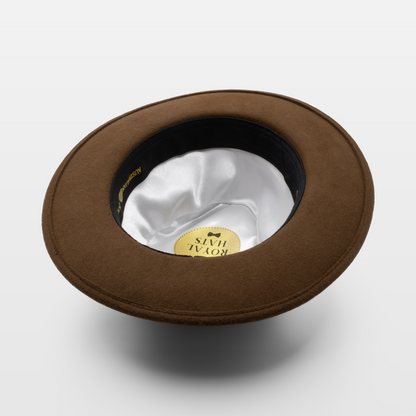 Brown wide-brimmed hat shown upside down to display the white satin interior