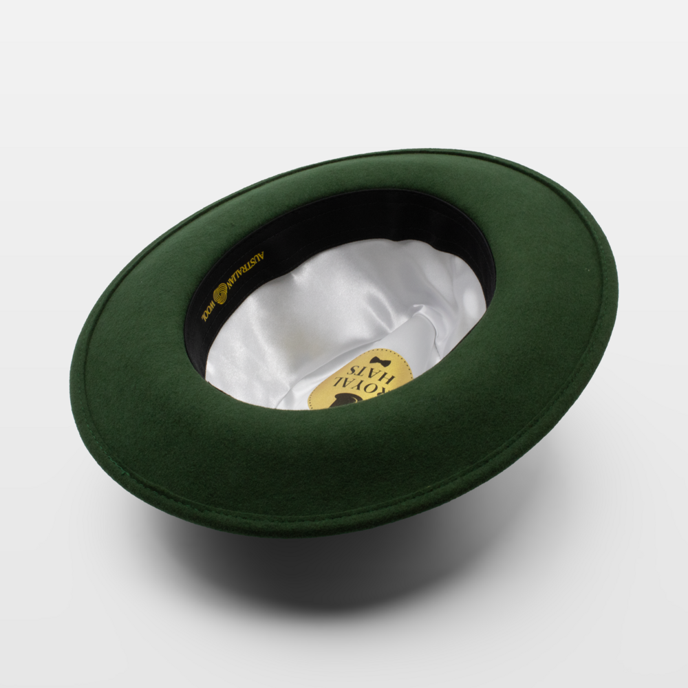 Green wide-brimmed hat shown upside down to display the white satin interior