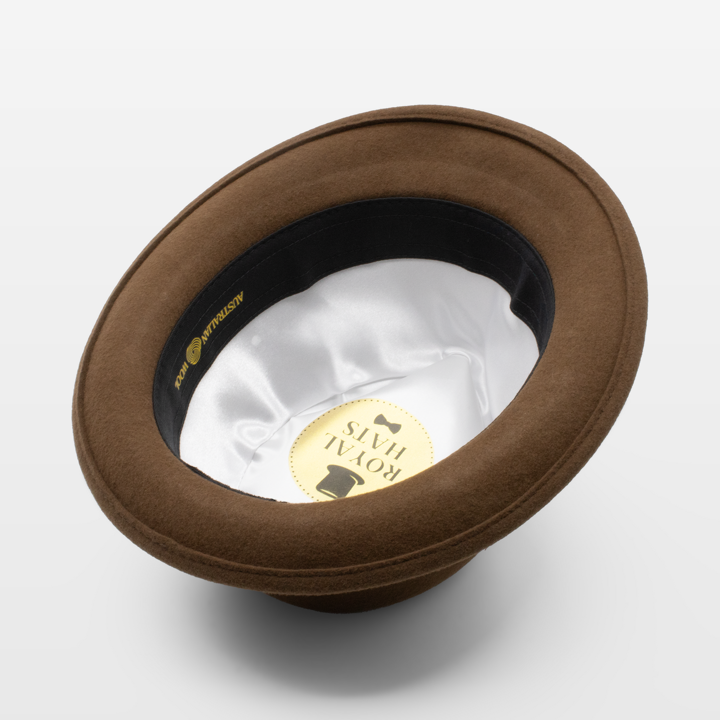 Brown fedora hat shown upside down to display the white satin interior