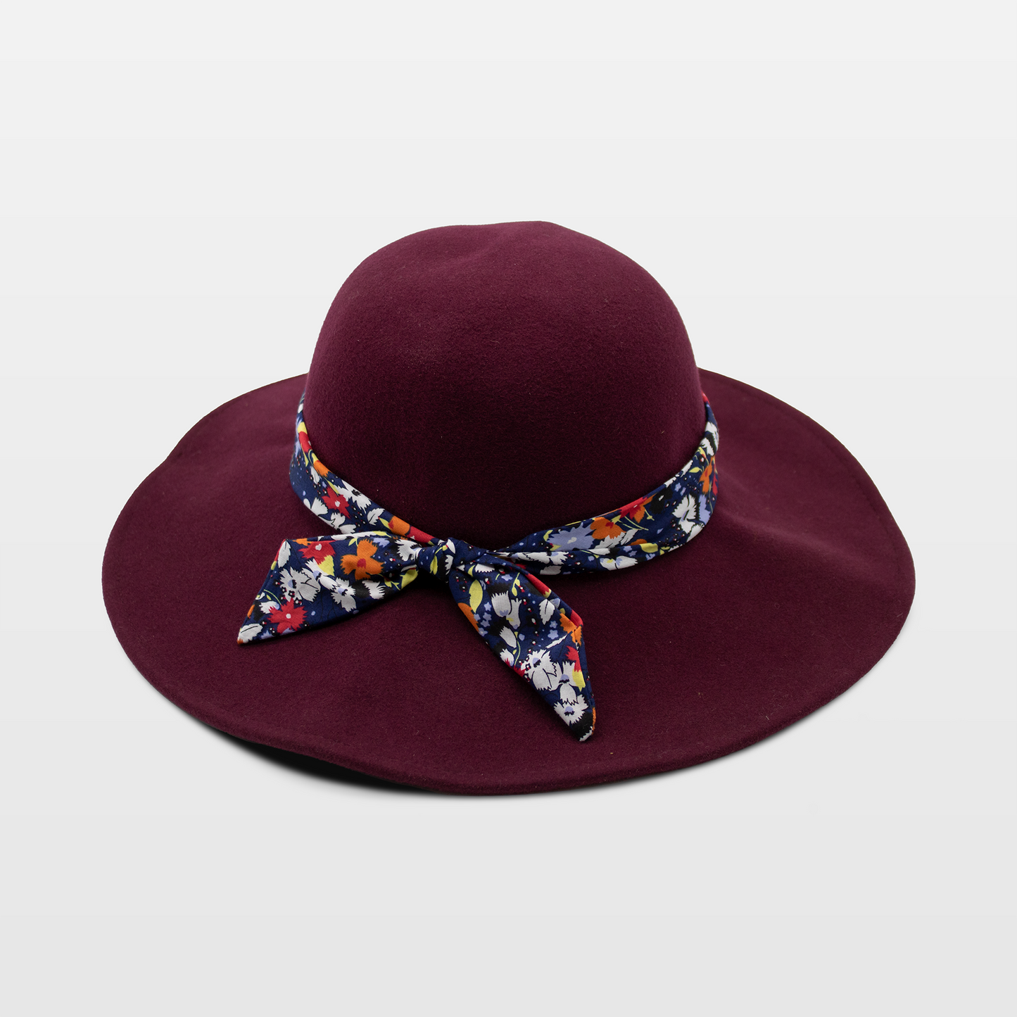 Maroon hat with a wide brim, adorned with a floral-patterned band tied in a bow