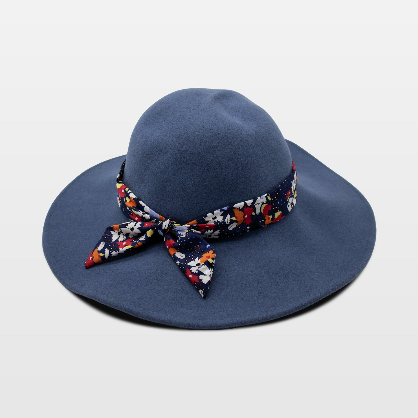 A stylish navy blue hat with a wide brim, with a colorful floral-patterned band tied in a bow