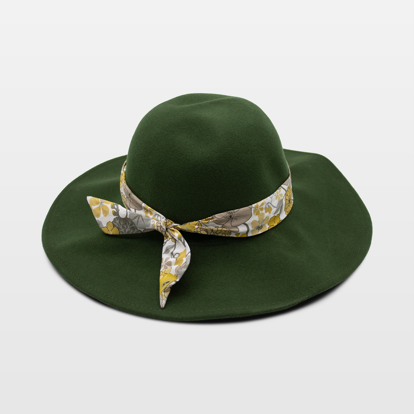 A stylish green hat with a wide brim, adorned with a floral-patterned band tied in a bow